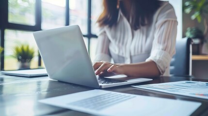 Generative AI : Women work on laptop on the table at the office with information documents.