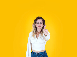 Showing thumb up, portrait of cheerful beautiful cute lady showing thumb up gesture. Stylish casual outfit modern wave blonde hair. Isolated yellow background. Copy space. Approve, advice concept. - obrazy, fototapety, plakaty