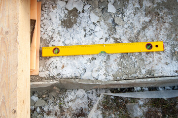 Yellow construction ruler on a construction site - 755391381