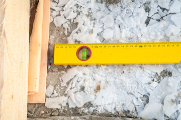 Yellow construction ruler on a construction site - 755391543