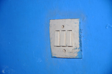 light switch on the blue wall