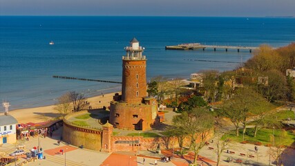 A sunny day in February at Kołobrzeg port, Poland. The image captures a red brick lighthouse.
 - obrazy, fototapety, plakaty