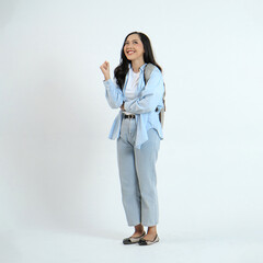 backview full leght shoot of happy asian Indonesian woman wearing casual attire and backpack on isolated background