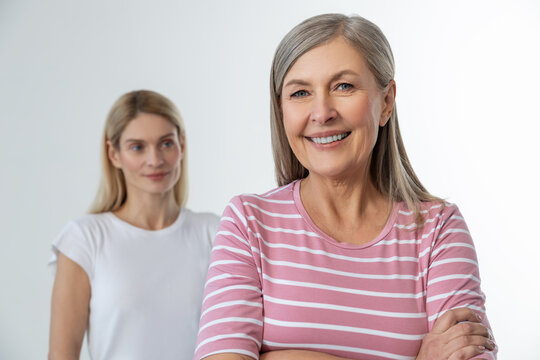 Two women on a studio photo smiling and looking confident