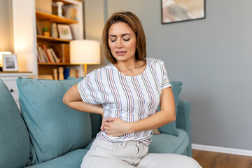 Back Pain. Closeup Of young woman Having Spinal Or Kidney Pain, Backache. Girl Suffering From...