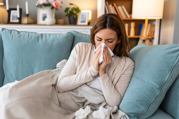 Cold And Flu. Portrait Of Ill Woman Caught Cold, Feeling Sick And Sneezing In Paper Wipe. Closeup Of Beautiful Unhealthy Girl Covered In Blanket Wiping Nose. Healthcare Concept.