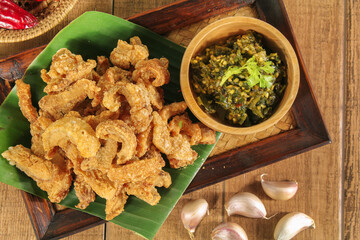 Homemade crispy pork rind with green chili paste. Local food of northern Thailand.