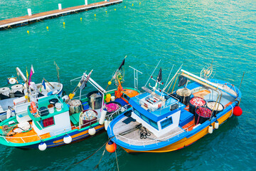 Colorful fishing boats on the pier in Amalfi coast, Italy. Mediterranean sea coast.