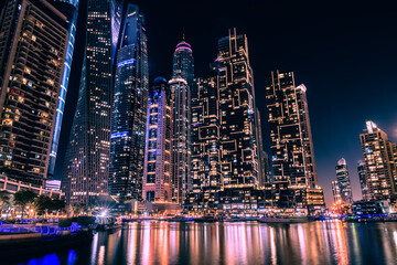 Fototapeta na wymiar Dubai Marina with modern skyscrapers at night. Dubai, United Arab Emirates.