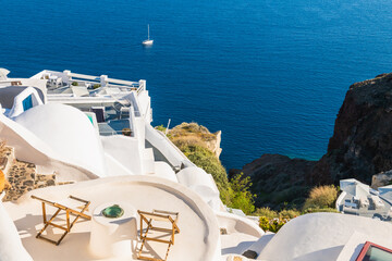 White architecture in Santorini island, Greece. Two chaise lounges on the terrace with sea view