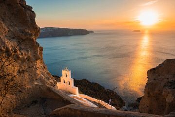Church of Agios Nikolaos in Santorini island, Greece. View of the sea and volcanic rocks at sunset.