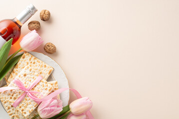 Festive Passover table setting: Top-view photo showing matzah with a bow, a bottle of red wine, walnuts, and fresh tulips, on a pastel beige background with space for words
