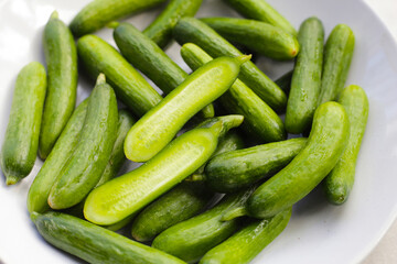Mini cucumbers on white background.