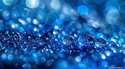A mesmerizing display of sparkling blue water droplets on a shiny surface creating a magical bokeh effect reminiscent of a glittering sapphire sea.