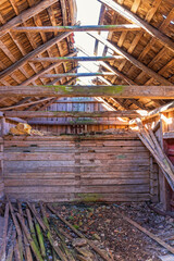 Interior of an old barn with a broken roof