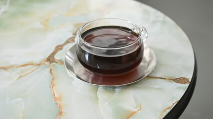drip coffee in very nice cup on marble table