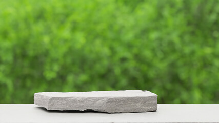 Podium with green forest blur background