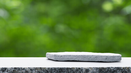 Podium with green forest blur background