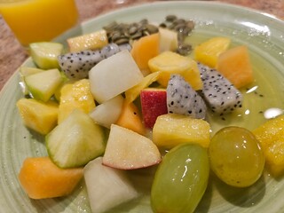 Fresh fruit salad on a plate and berries