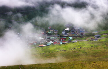 Mountain landscape panorama with ocean. Fog over the Funningur fjord on Eysturoy Island, Faroe Islands. - 755435913