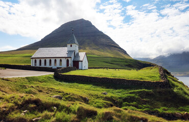 Church by the sea with ocean and mountain panorama, Vidareidi, Faroe Islands, Denmark, Northern Europe