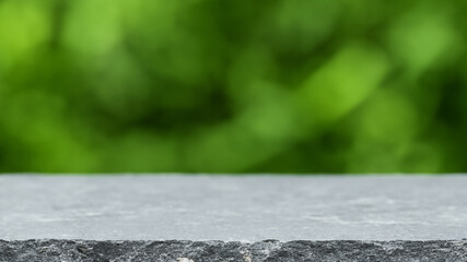 Podium with green forest blur background