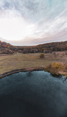 Aerial vertical panorama on river in autumn valley with epic cloudy sky in Ukraine