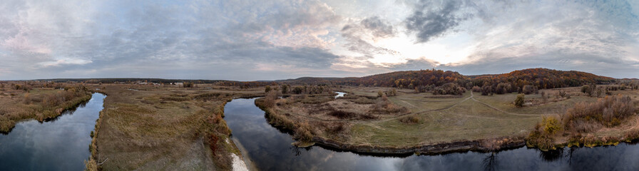 Fototapeta na wymiar Aerial panorama of river in autumn valley with scenic sunset cloudy sky in Ukraine