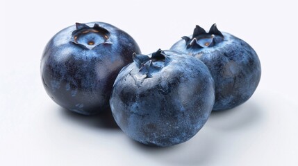 a group of blueberries on a white surface