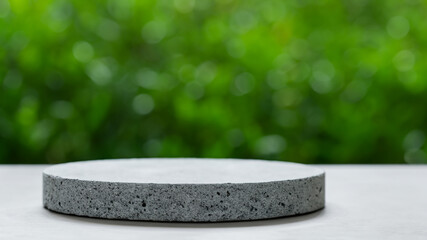 Podium with green forest blur background