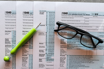 pen lies on 1040 U.S tax form.  Revenue Service tax filing deadline