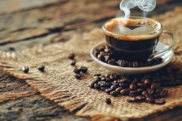 Tuinposter Cup of coffee with  smoke and coffee beans on burlap sack on old wooden background © Eyepain