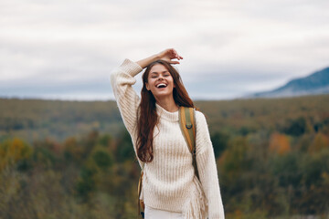 Mountain Adventure: Smiling Woman Trekking on Cliff, Enjoying Nature and Freedom