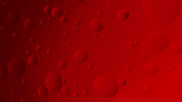 Revolving red bubbles in fluid space.