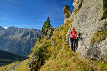 Austria, Tyrol, Female hiker following Aschaffenburger Hohenweg trail in Zillertal Alps