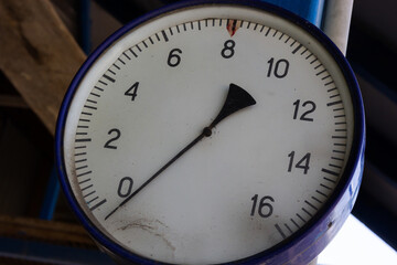 Old round manometer with scale and arrows close-up