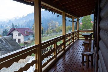 Fototapeta na wymiar Beautiful modern terrace lounge, a large wooden terrace in a wooden house with a forest around. Nature and vacation concept