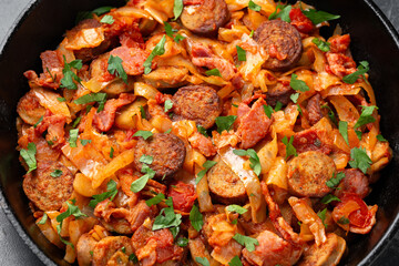 Stew cabbage with a sausage and bacon.