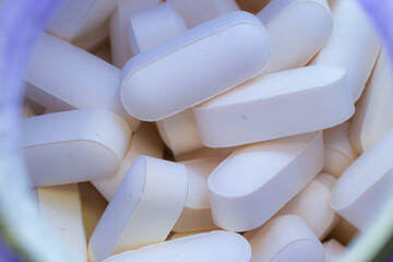 Pills drugs tablets vitamins macro image close up white. Medicine, healthcare concept. Range of pharmaceutical drugs