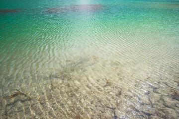 Blue turquoise saturated water of Kulikalon Lake in the Fan Mountains in Tajikistan, cold mountain lake