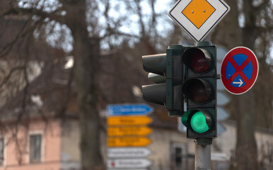 Green traffic light on blue cloudy sky background