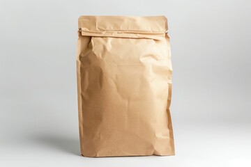 A brown paper bag is sitting on a white surface. The bag is open and has a white label on it