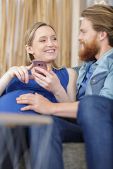 Obraz na płótnie Canvas husband and pregnant wife - parenthood