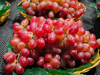 Fresh red grapes fruit in basket at the market
