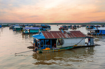 Village on the water of Tonle Sap lake in Cambodia. Beautiful lighting, sunset.