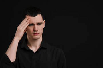 Obraz premium Portrait of sad man on black background, space for text