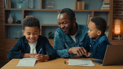 Happy smiling family e-learning home education African American father man private teacher with two...