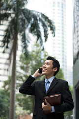 Chinese business man using a smartphone.