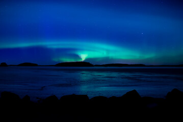 Northern lights dancing over frozen lake in Farnebofjarden national park in north of Sweden. - 755489933