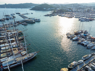 Magnificent drone view of the beautiful, yacht-filled harbor of Bodrum in Mugla province in Turkey at sunset.